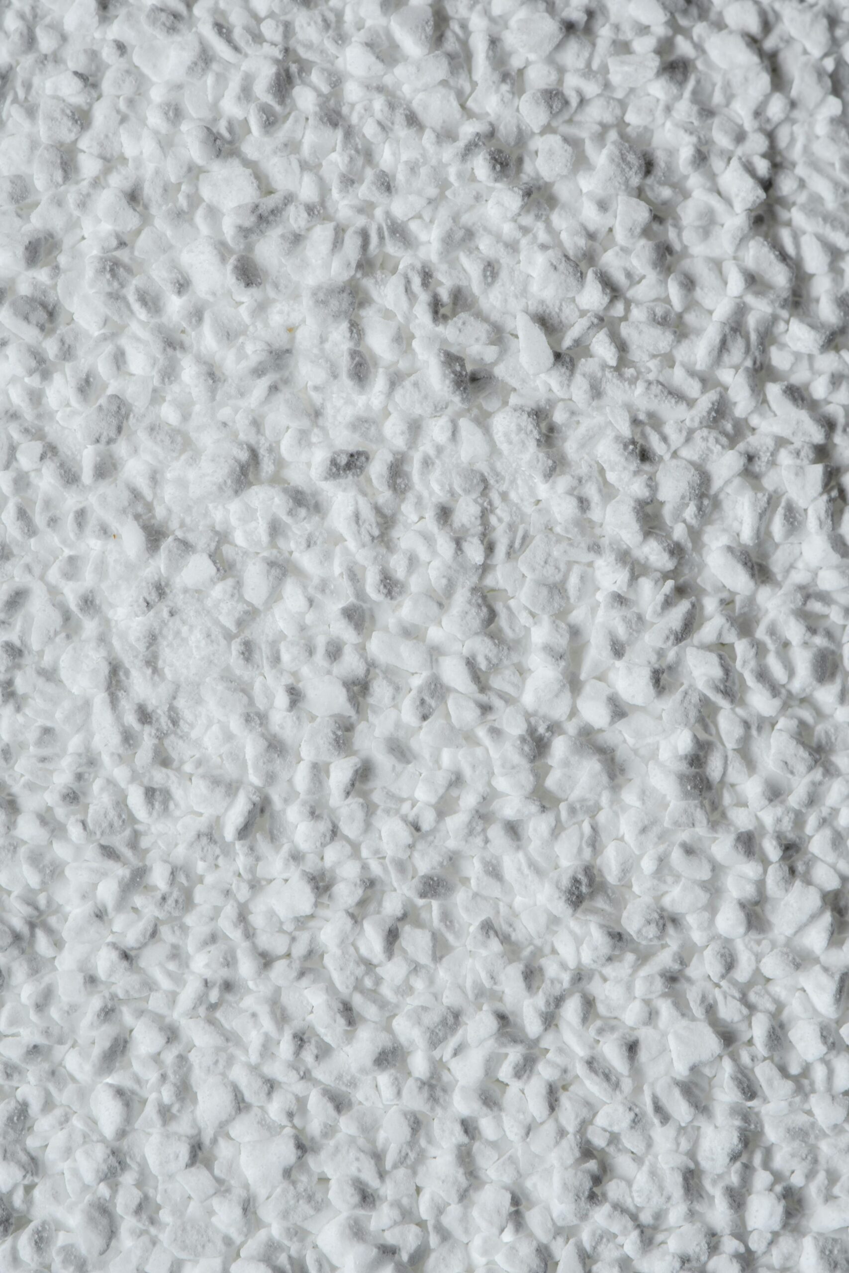 Detailed close-up texture of granulated white sugar, ideal for food and culinary themes.